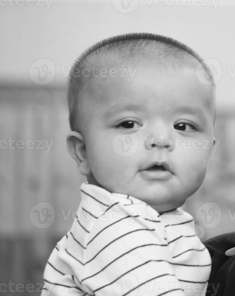 Cute Asian Pakistani Baby Boy is Posing in the Home Garden During Cloudy Day over Luton, England UK. Image Was Captured on July 23rd, 2023 photo