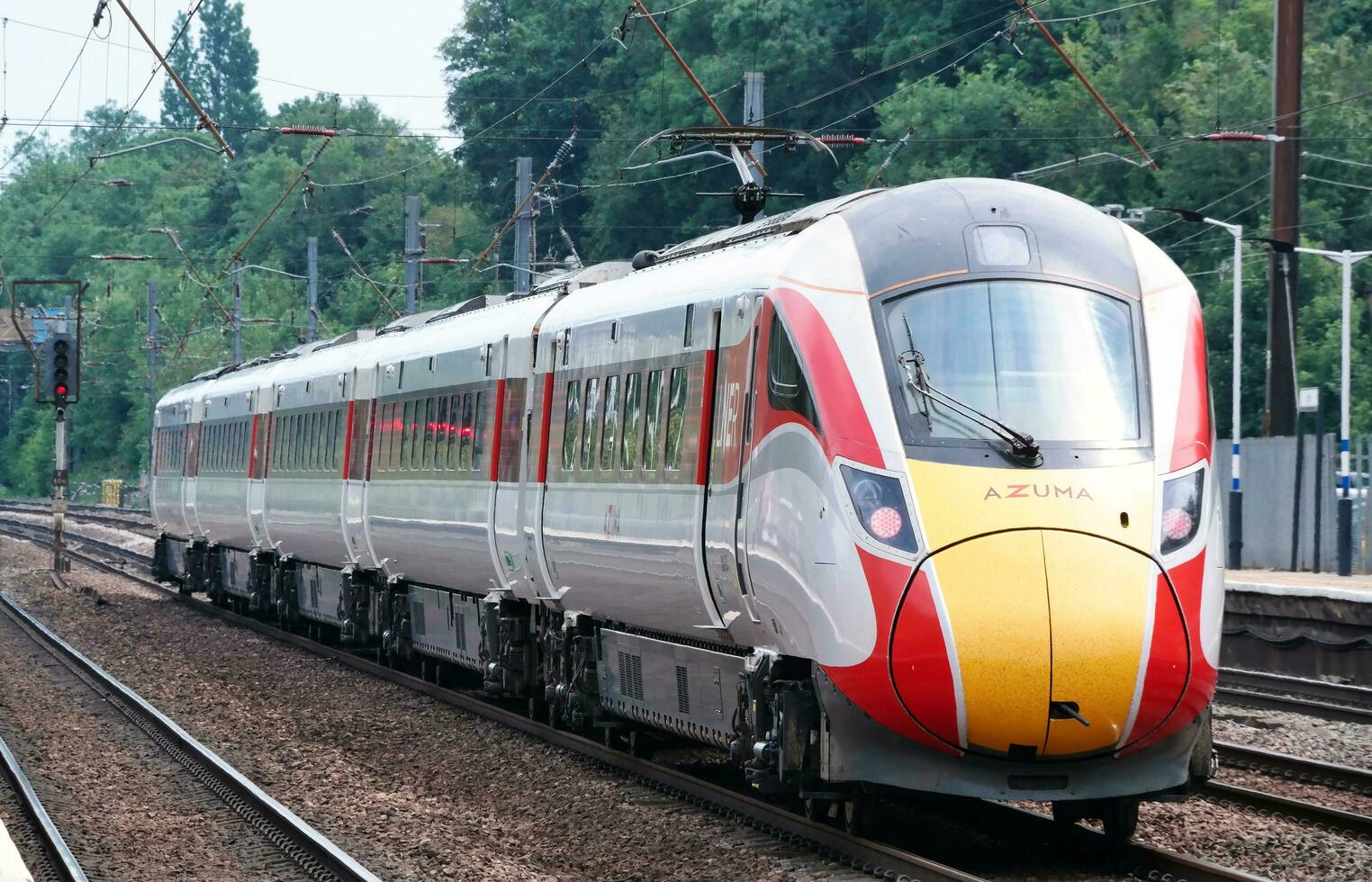 Gorgeous View of Fast Train on Tracks Which is Passing Through Hitchen Town Railway Station and Platform Nonstop to London. Image Was Captured on June 18th, 2023 photo