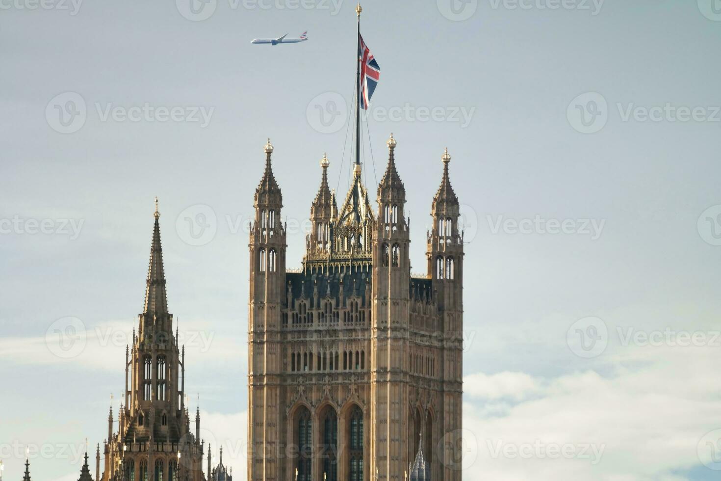 Beautiful Low Angle View of Historical Big Ben Clock Tower from river Thames and London Eye, Westminster Central London, England Great Britain, UK. Image Captured During Cloudy Day of August 2nd, 2023 photo