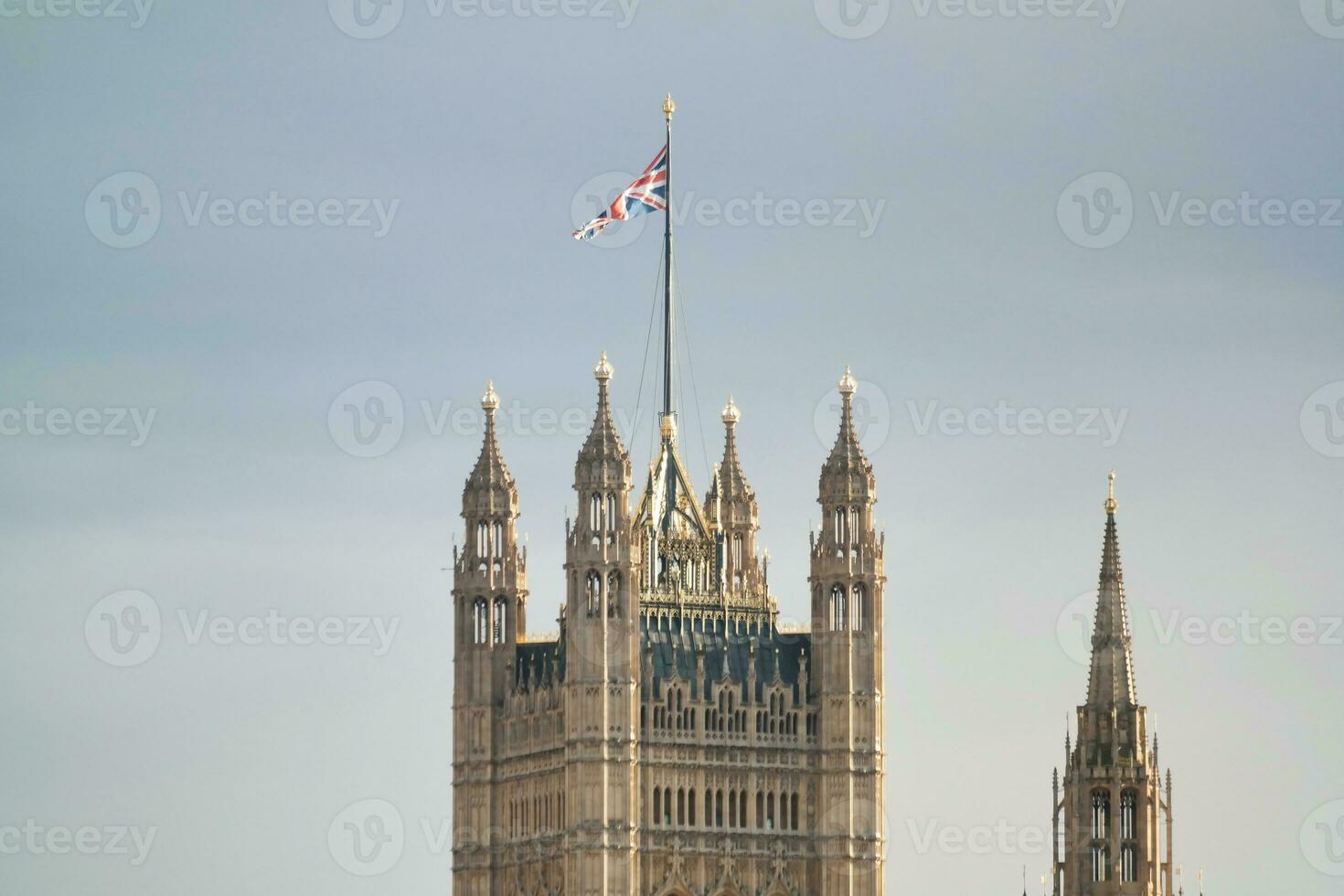 Beautiful Low Angle View of Historical Big Ben Clock Tower from river Thames and London Eye, Westminster Central London, England Great Britain, UK. Image Captured During Cloudy Day of August 2nd, 2023 photo