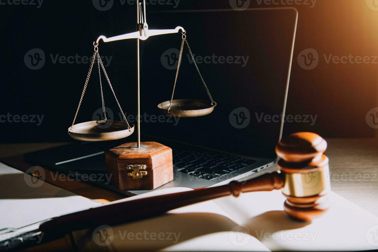 law legal technology concept. judge gavel on computer with scales of justice on desk of lawyer. photo