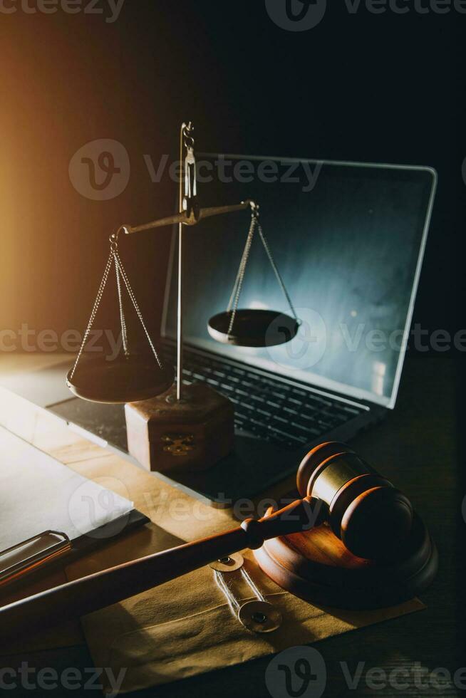 law legal technology concept. judge gavel on computer with scales of justice on desk of lawyer. photo