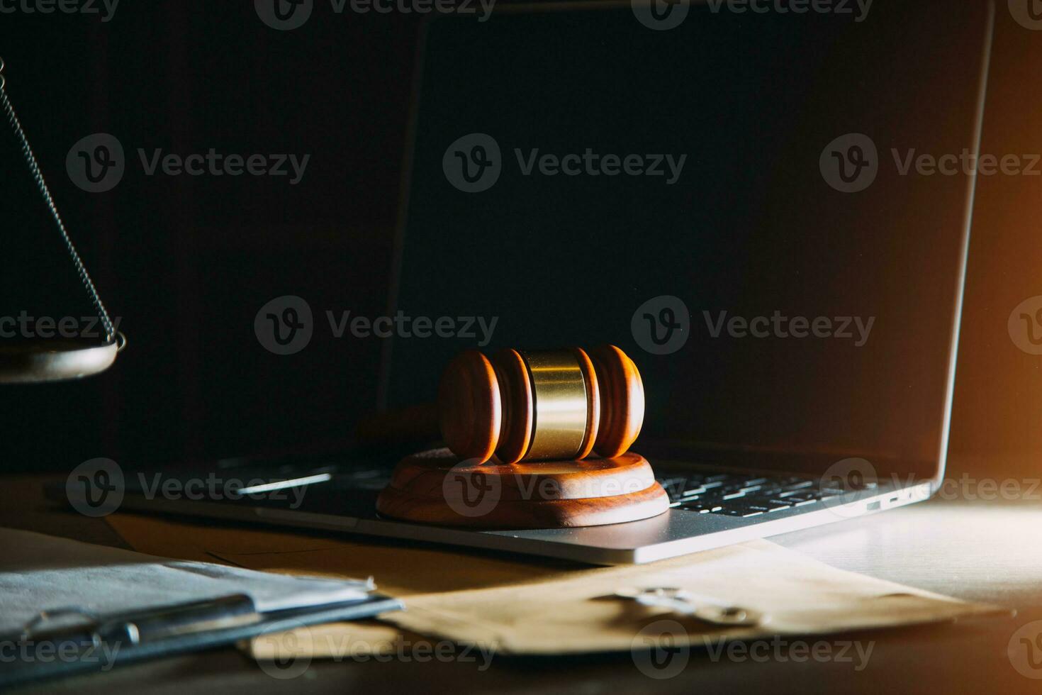 law legal technology concept. judge gavel on computer with scales of justice on desk of lawyer. photo
