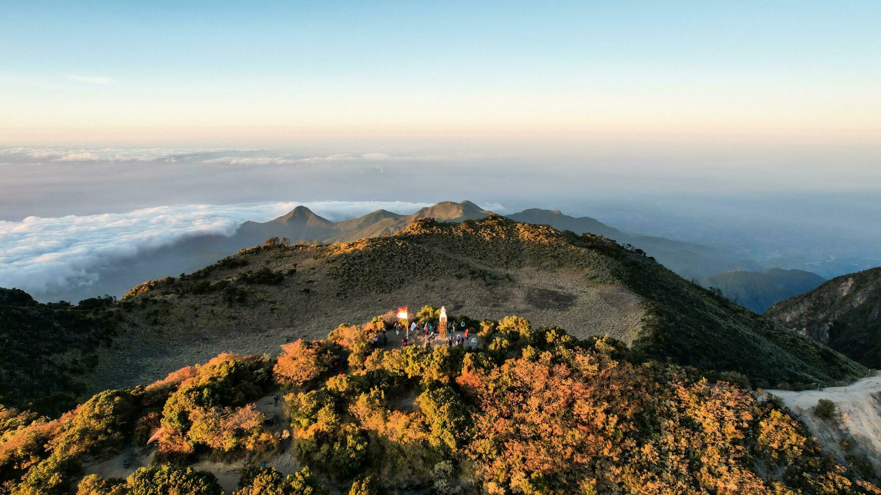 The beautiful Landscape view from Lawu Mountain at sunrise located in Magetan. One of the most beautiful mountains in Java with an altitude of 3265m above sea level. Magetan, Indonesia August 1, 2023 photo