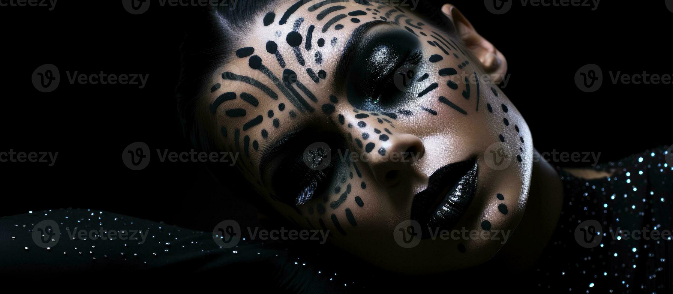 Abstract body painting art featuring a young woman with black hair lying on a shiny black floor with creative black dot accents photo