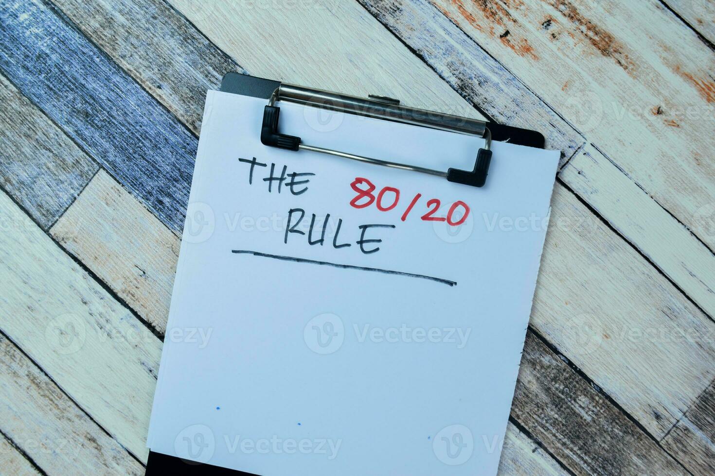 Concept of The 80-20 rule write on paperwork isolated on Wooden Table. photo