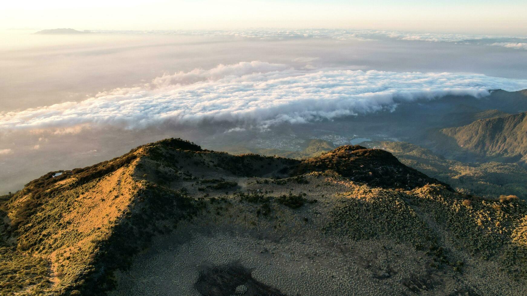 The beautiful Landscape view from Lawu Mountain at sunrise located in Magetan. One of the most beautiful mountains in Java with an altitude of 3265m above sea level. Magetan, Indonesia August 1, 2023 photo