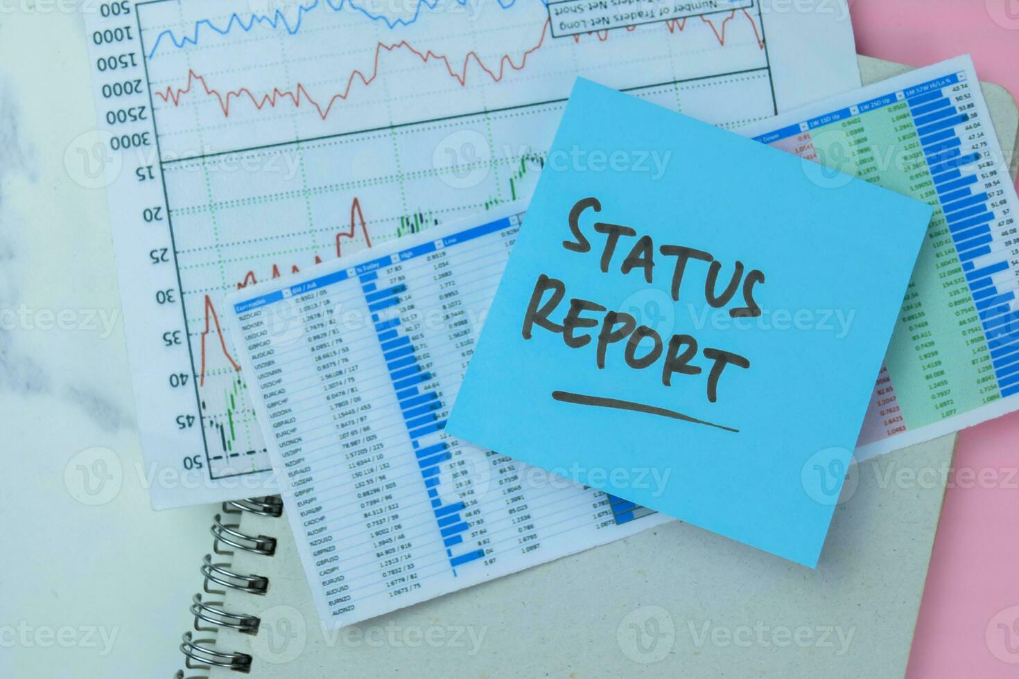 Concept of Status Report write on sticky notes isolated on Wooden Table. photo