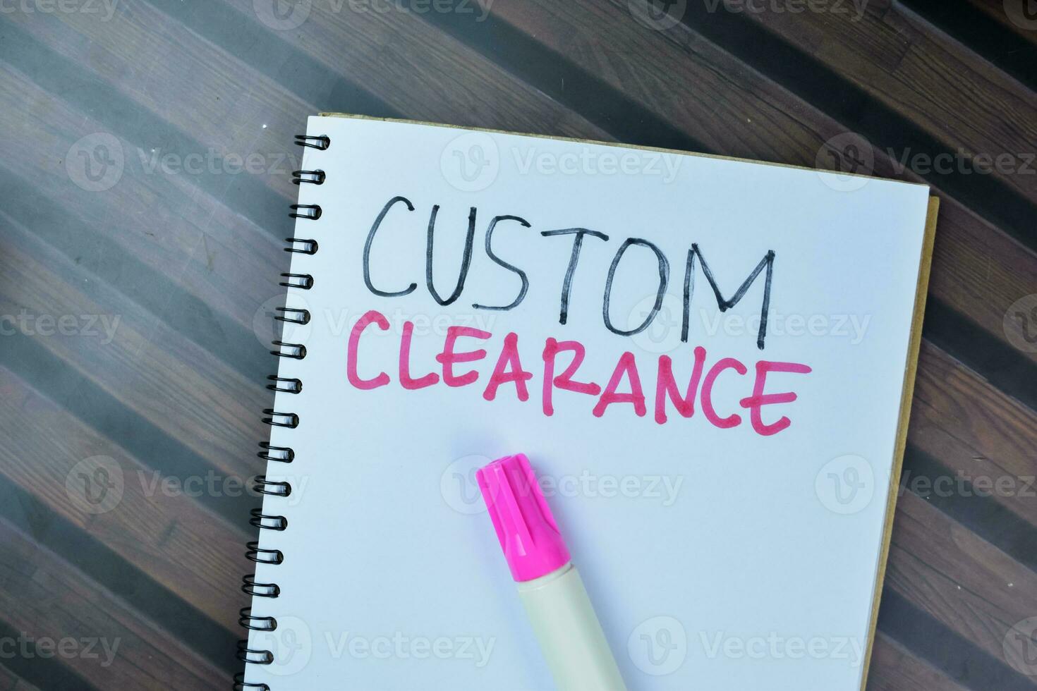 Concept of Custom Clearance write on book isolated on Wooden Table. photo
