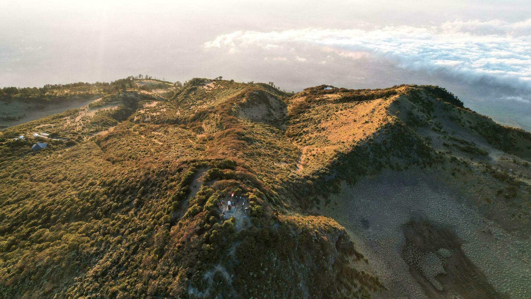 The beautiful Landscape view from Lawu Mountain at sunrise located in Magetan. One of the most beautiful mountains in Java with an altitude of 3265m above sea level. Magetan, Indonesia August 1, 2023 photo