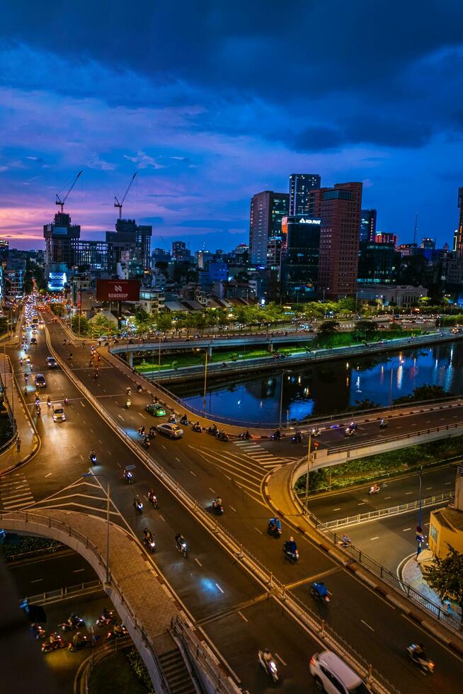 Ho Chi Minh, Viet Nam - 22 June 2023 Aerial view of Bitexco Tower, buildings, roads and Saigon river in Ho Chi Minh city photo