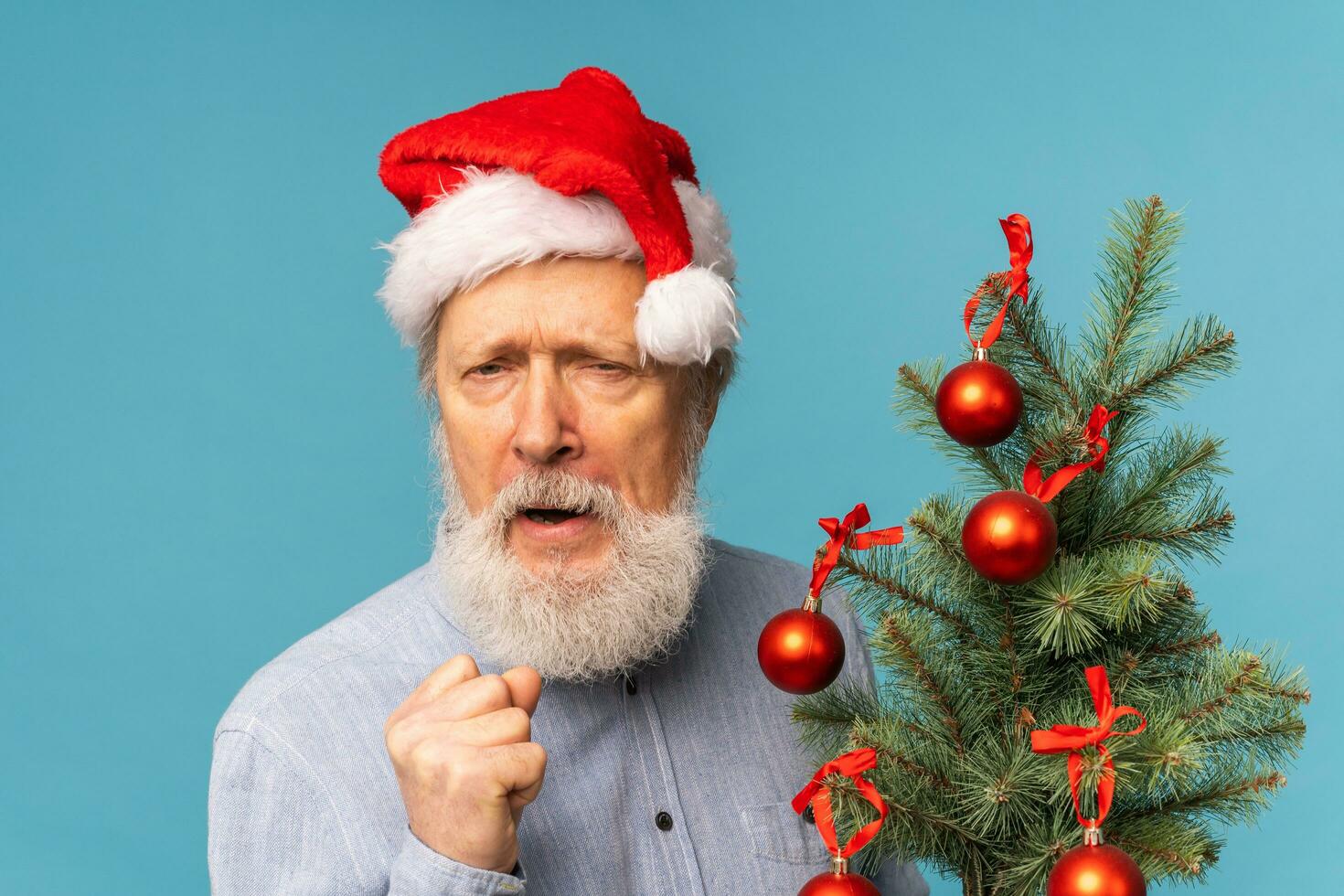Angry Santa scares kids, man wears santa hat show aggressive emotions - negative and bad mood Christmas concept photo