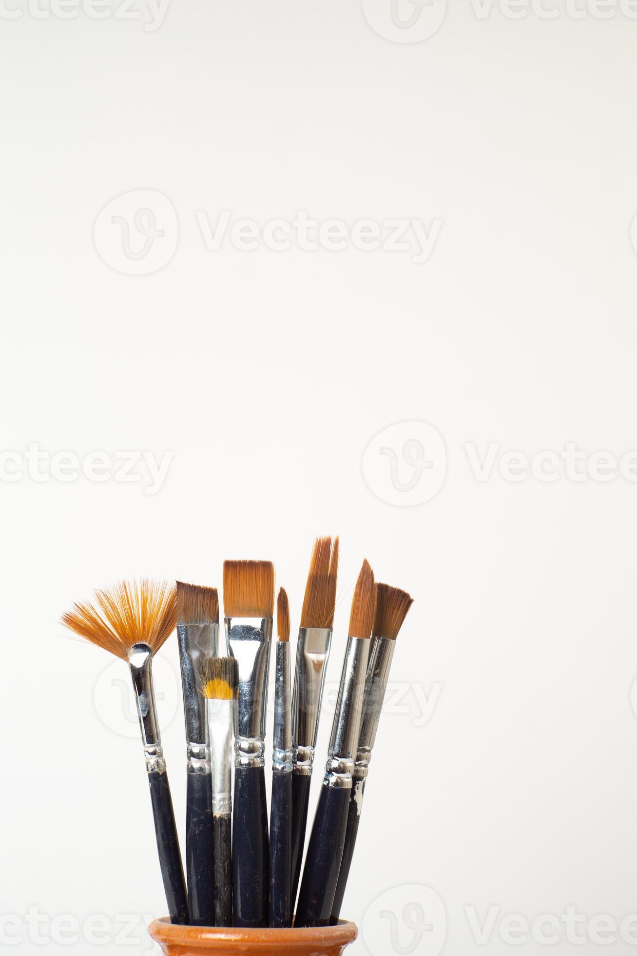 earthenware jar with brushes 27299611 Stock Photo at Vecteezy