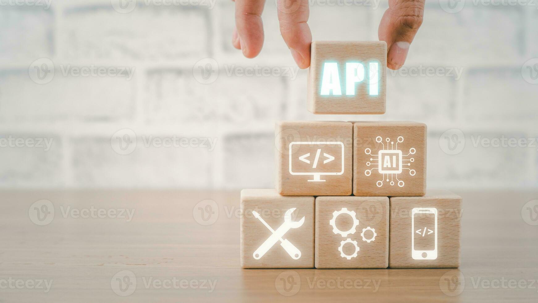 API - Application Programming Interface, Wooden block with VR screen API icon on office desk, Software development tool, modern technology, internet and networking concept. photo