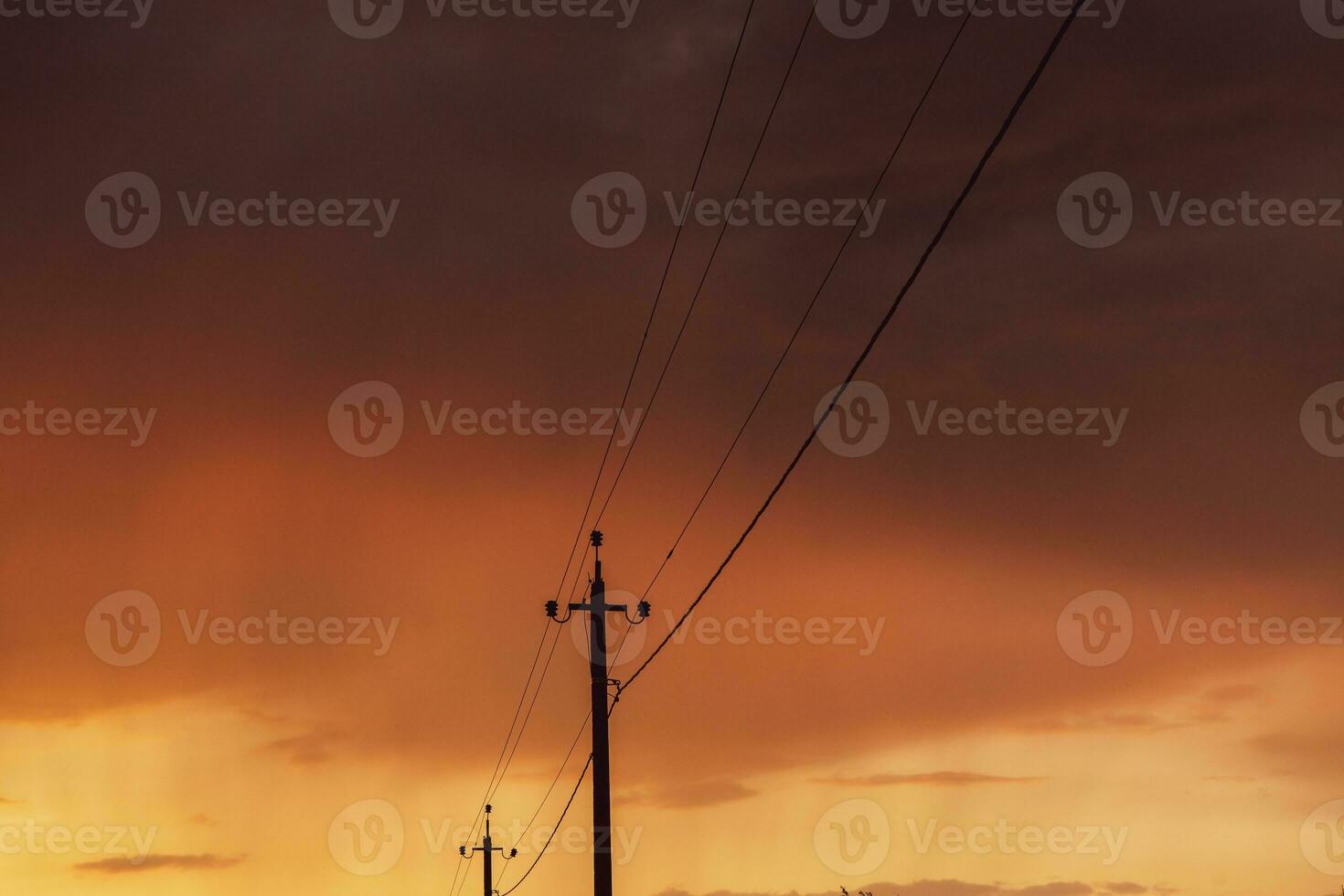 High-voltage power lines at sunset. Electricity distribution station.  electricity pylons on the background of the sky photo