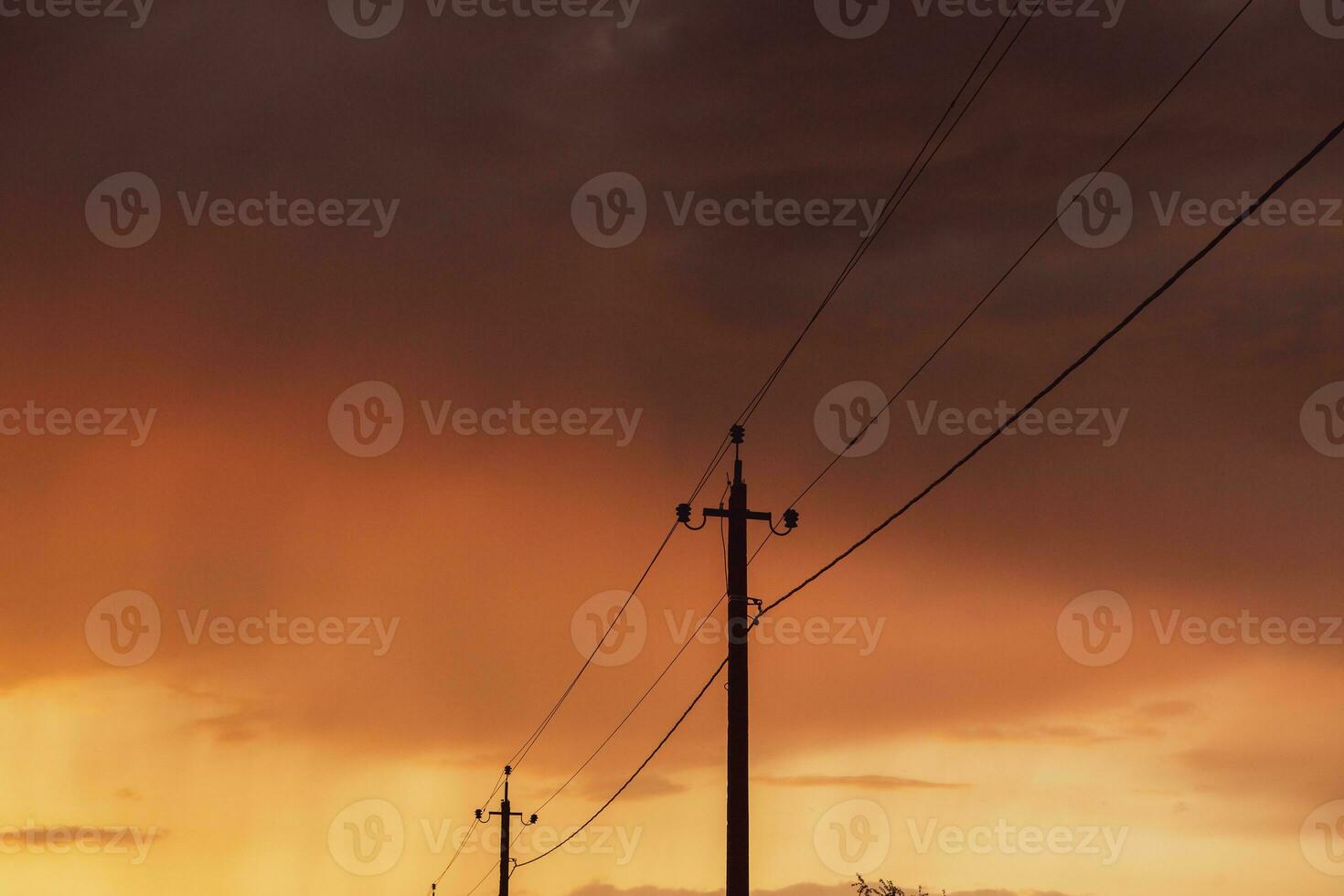 High-voltage power lines at sunset. Electricity distribution station.  electricity pylons on the background of the sky photo
