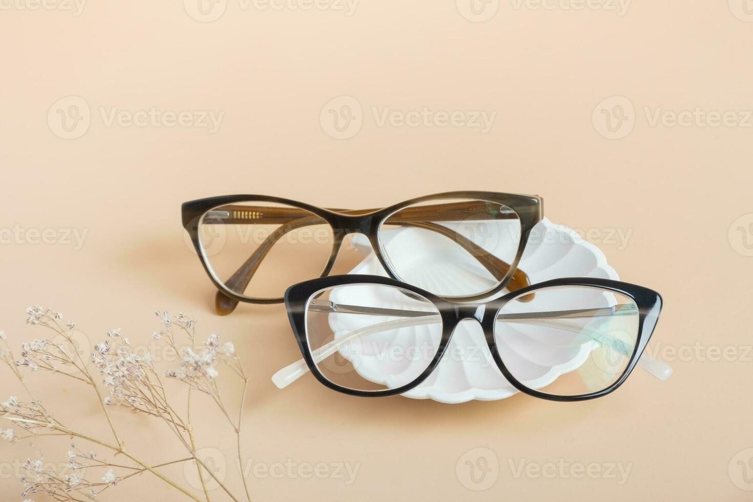 Gypsum elements with eyeglasses on colored background. Optical store, vision test, stylish glasses concept photo