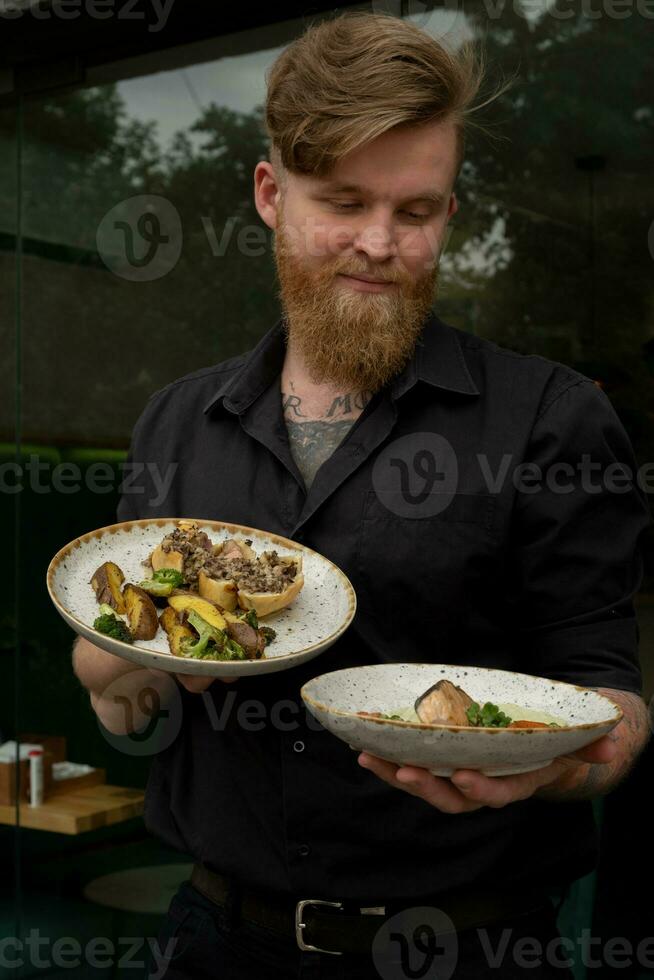 Cute bartender with two plates of food photo