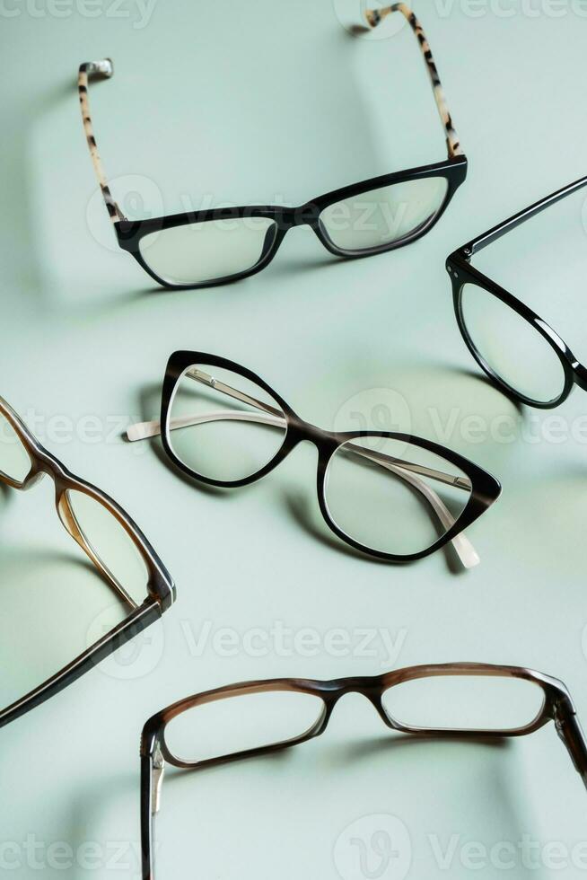 Stylish eyeglasses on colored background. Optical store, vision test, stylish glasses concept. photo