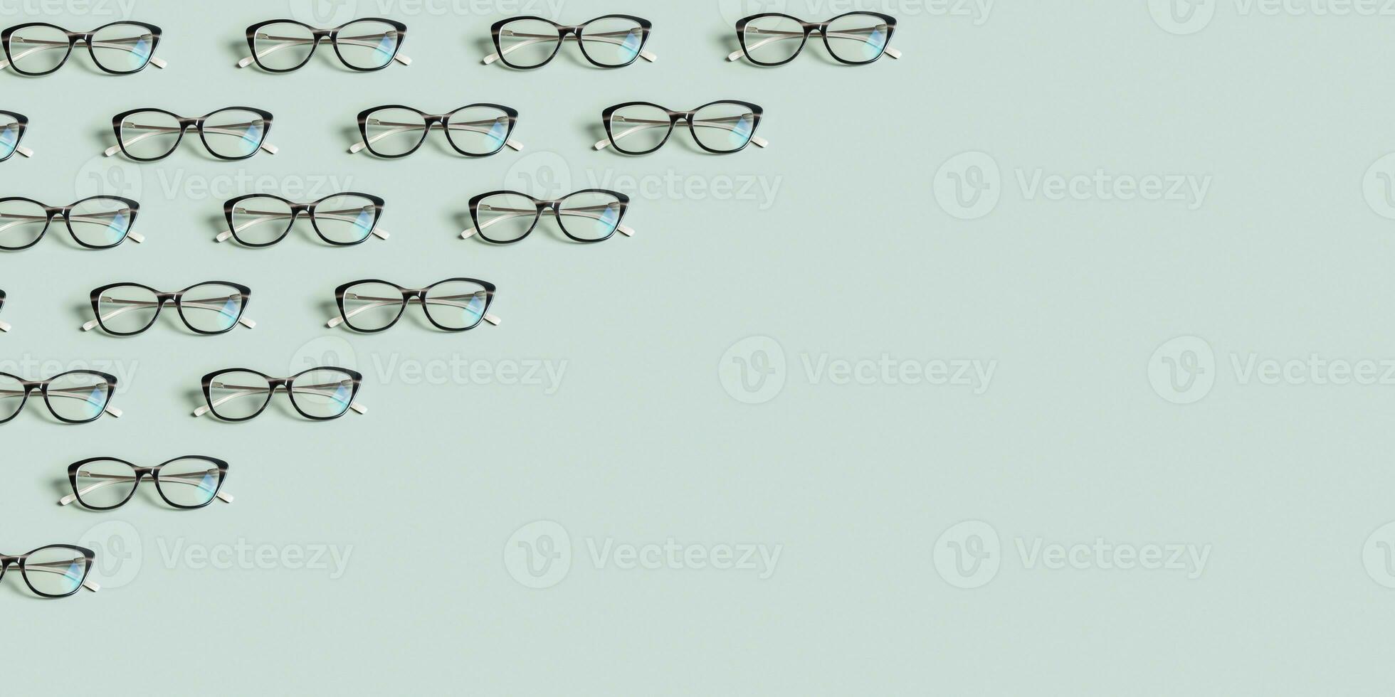 Glasses for vision on a green background. Optical store, vision test, stylish glasses concept. Banner with pattern photo