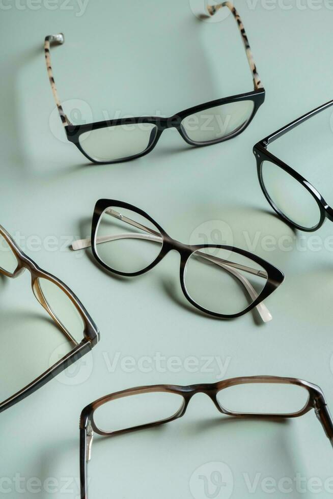 Stylish eyeglasses on colored background. Optical store, vision test, stylish glasses concept. photo