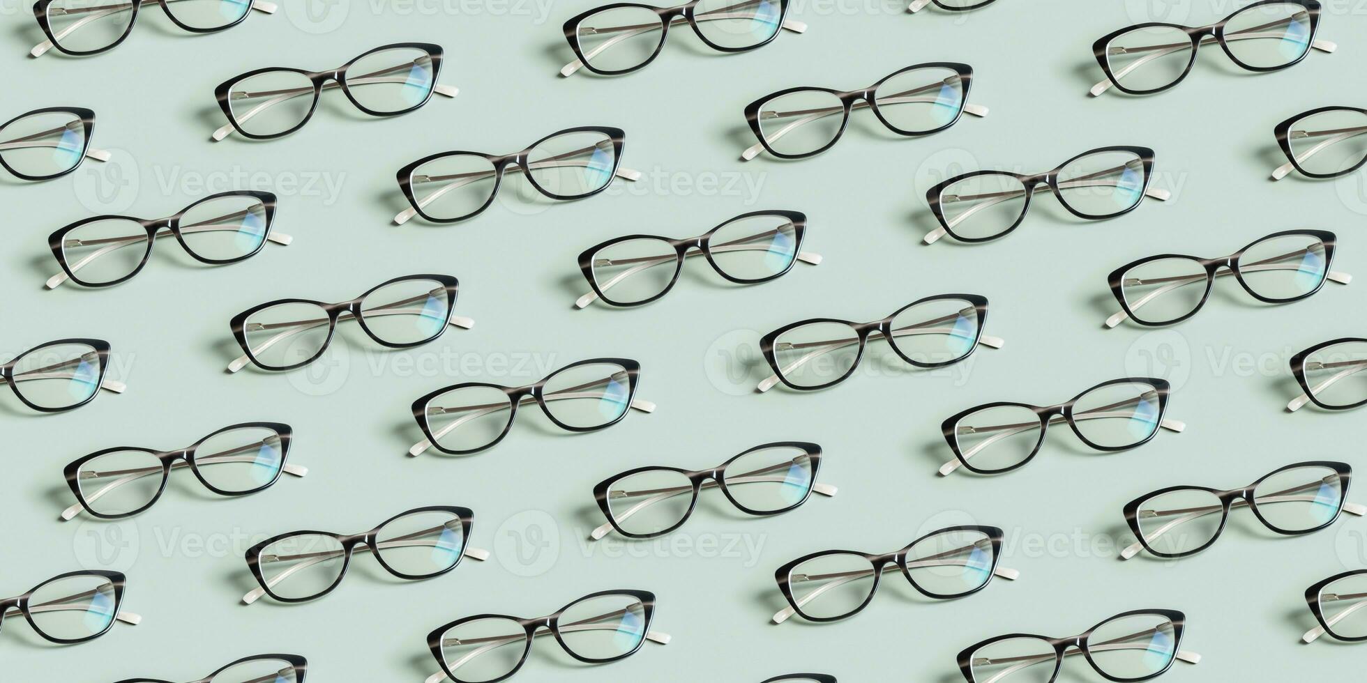 Glasses for vision on a green background. Optical store, vision test, stylish glasses concept. Banner with pattern photo