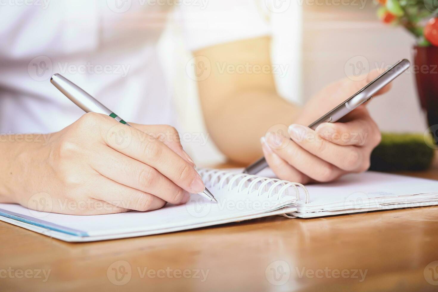 Business women writing and working on desk office. photo