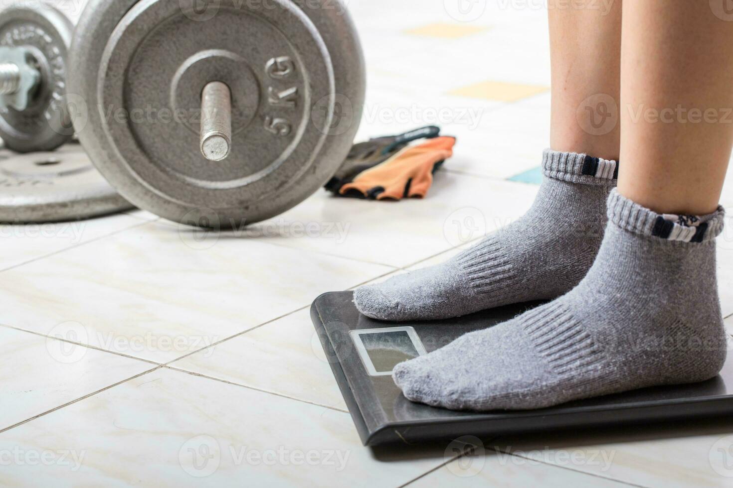 Close up female feet on digital weighting scale. photo