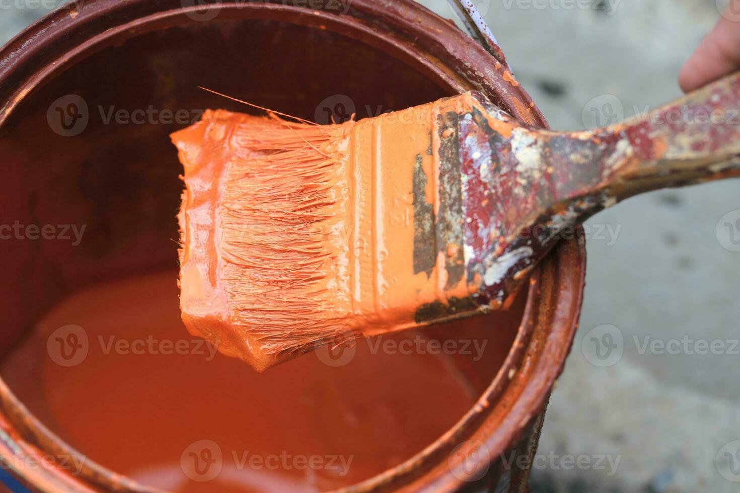 Old paint brush tool in the over the can. photo