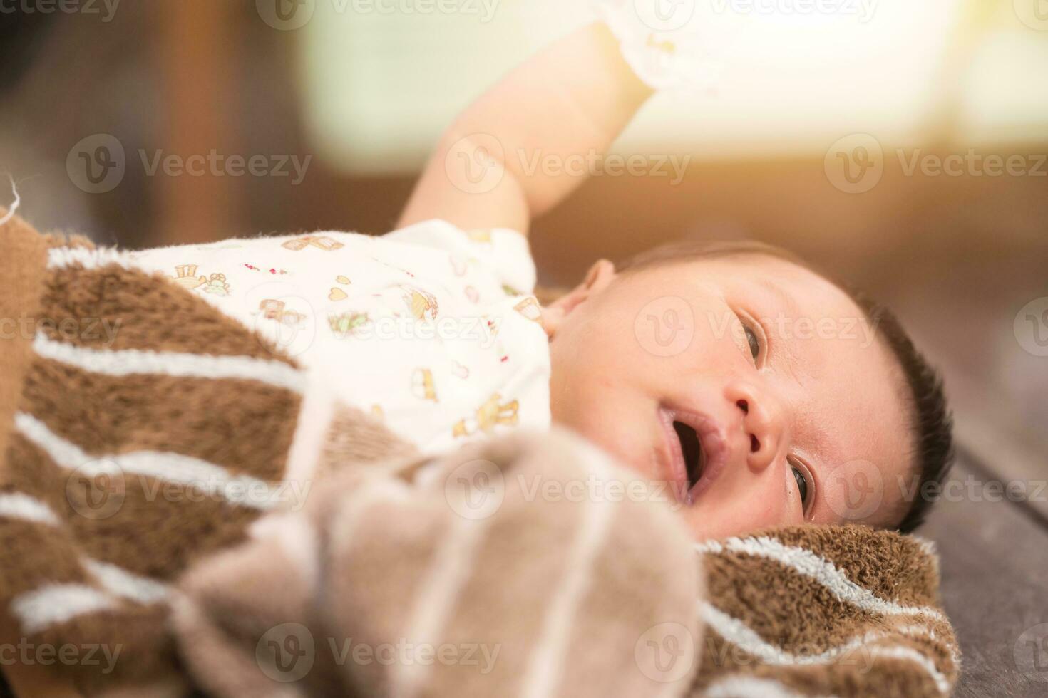 Newborn baby lying on fur fabric. photo