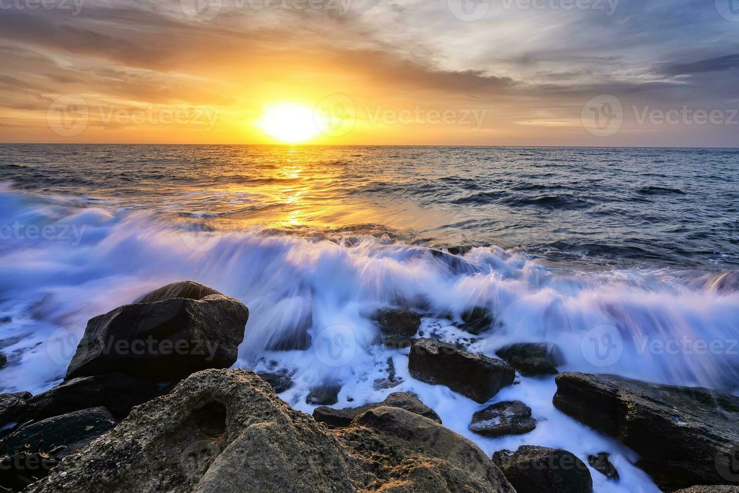 The stunning seascape with the colorful sky and water foam at the rocky coastline of the Black Sea photo