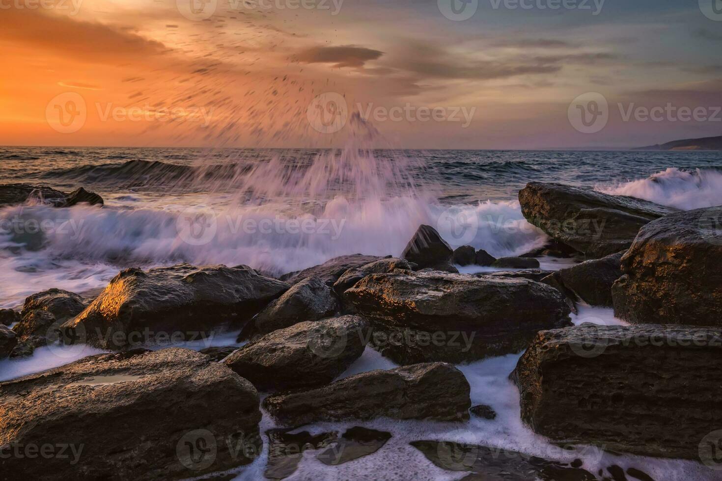 Amazing splash of seawater at morning on the shore of the Black Sea. Beautiful motion blur sea waves over the rocks. photo