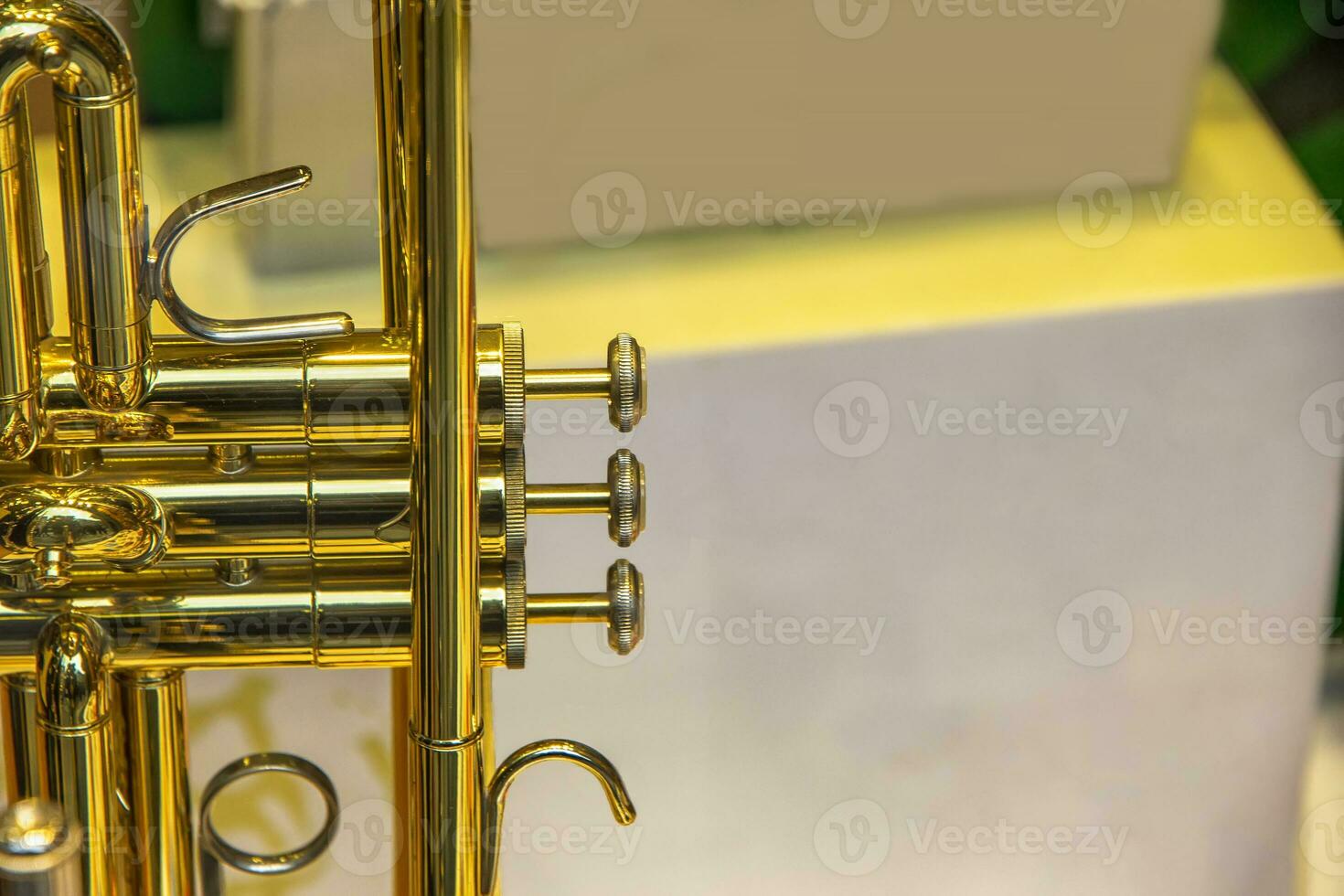 A part of the stunning golden trumpet with brass details. Close up of trumpet finger buttons valves photo