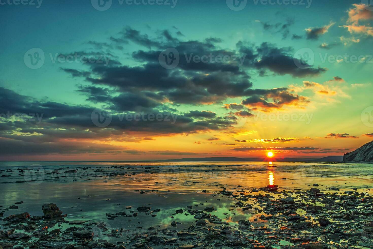 Magnificent sunset view at the Black sea coast, Bulgaria.Sea rocks at colorful sunset. photo