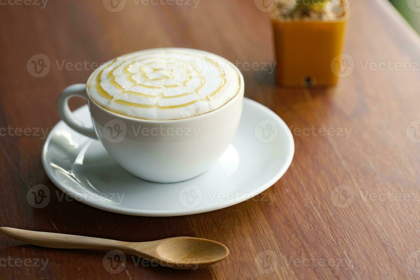 A cup of coffee on wooden table. photo