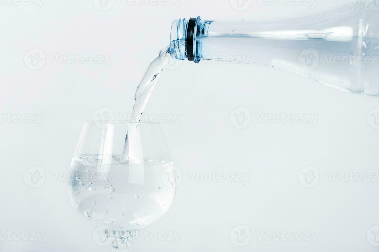Pour mineral water in the bottle on clean grass. photo
