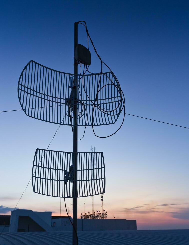 Antenna silhouette on sunset. photo