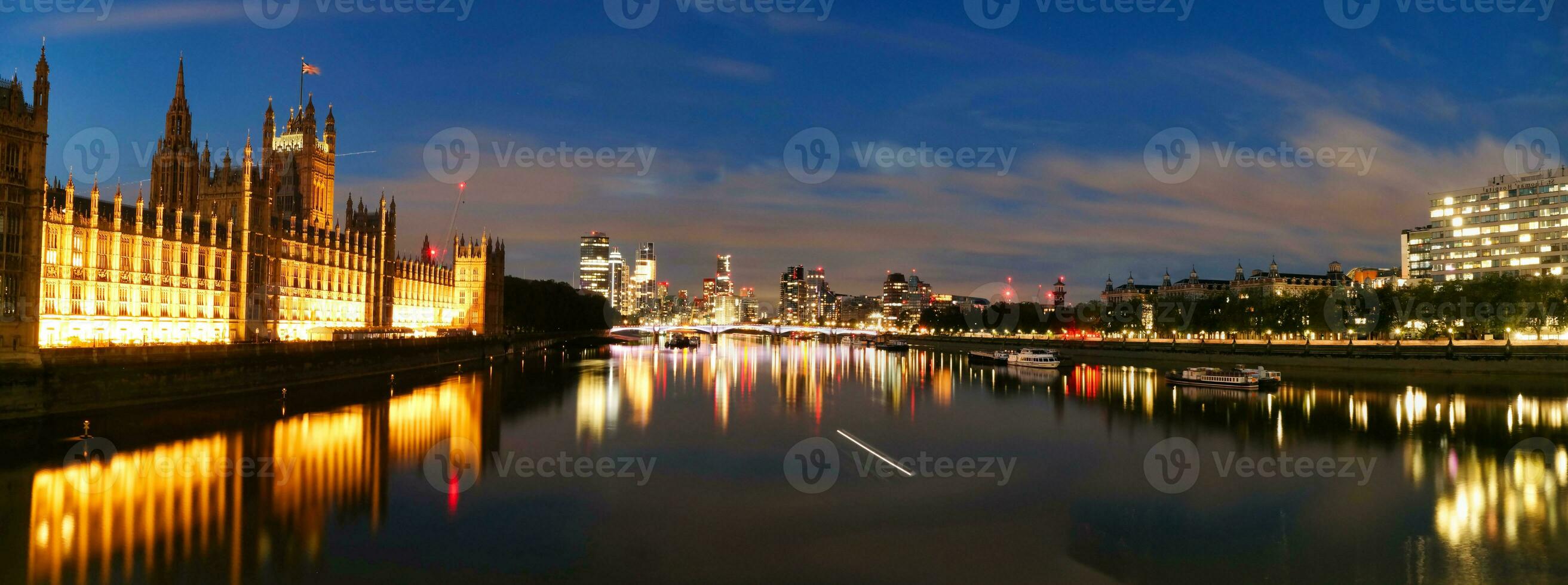 Most Beautiful Footage of Illuminated London eye from River Thames Westminster, Big Ben clock Tower at After Sunset Night. England Great Britain,  Footage Was Captured on Aug 02nd, 2023 After Sunset. photo