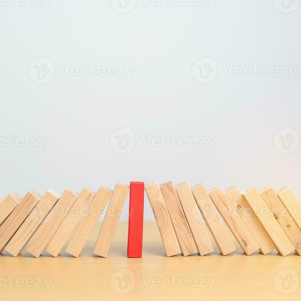 wood domino blocks falling on table. Crisis, fall Business, Risk management, Economic recession, Strategy and solutions concept photo