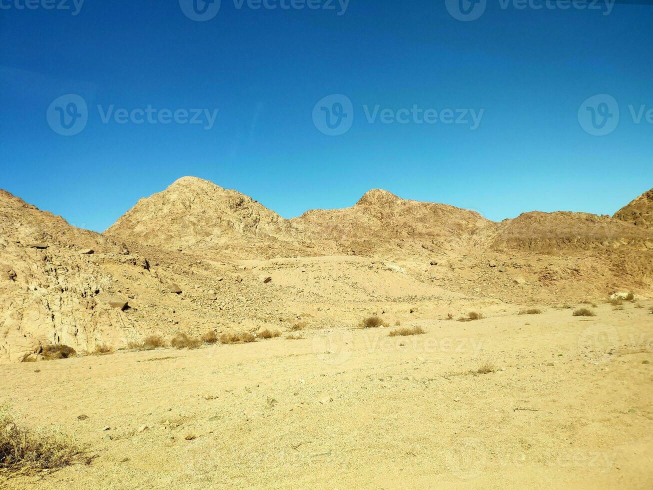 Desert land with mountains and sea photo
