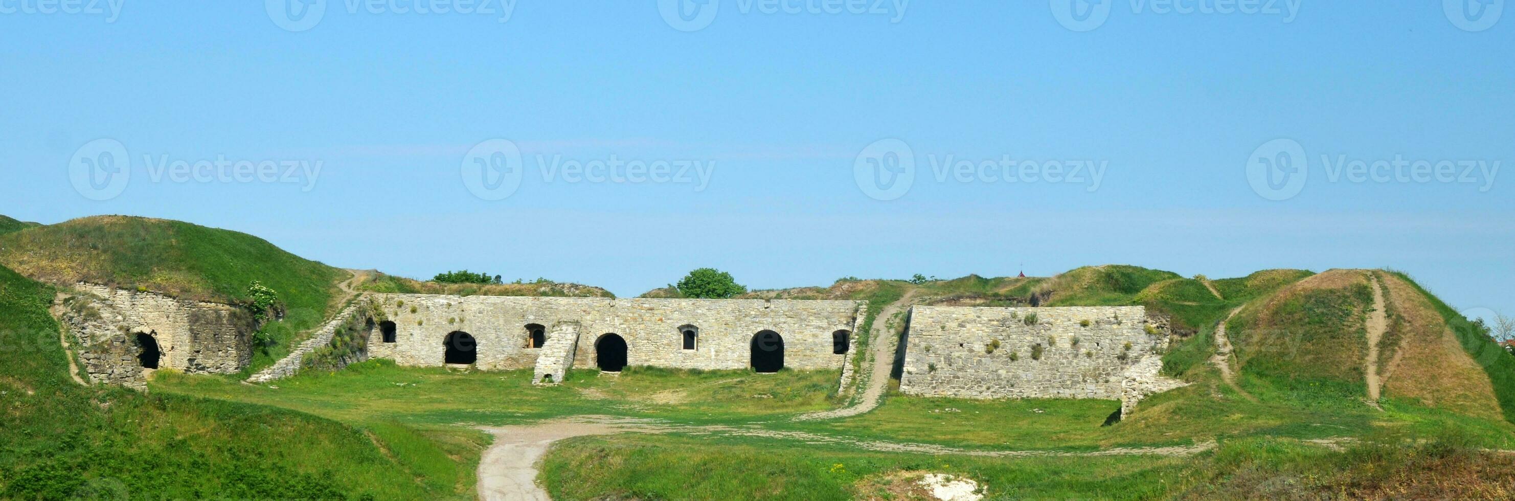 Medieval ruins of bank of fortress photo