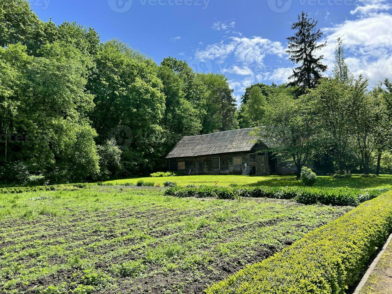 Old village house and vegetable garden in Vilnius University Botanical Garden photo