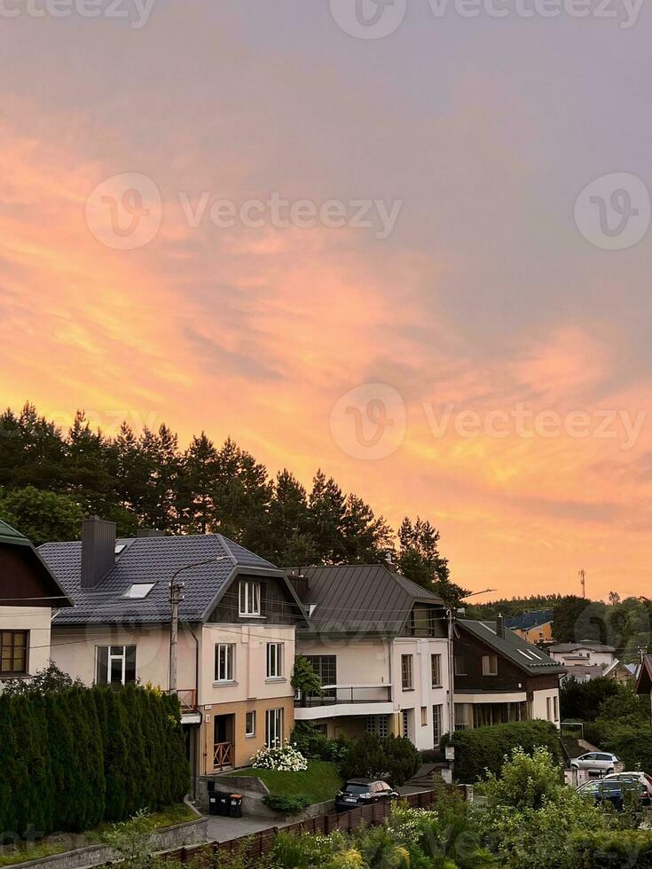 Sunset in the village overlooking the European houses and the forest. Modern private houses. Living in the middle of nature photo