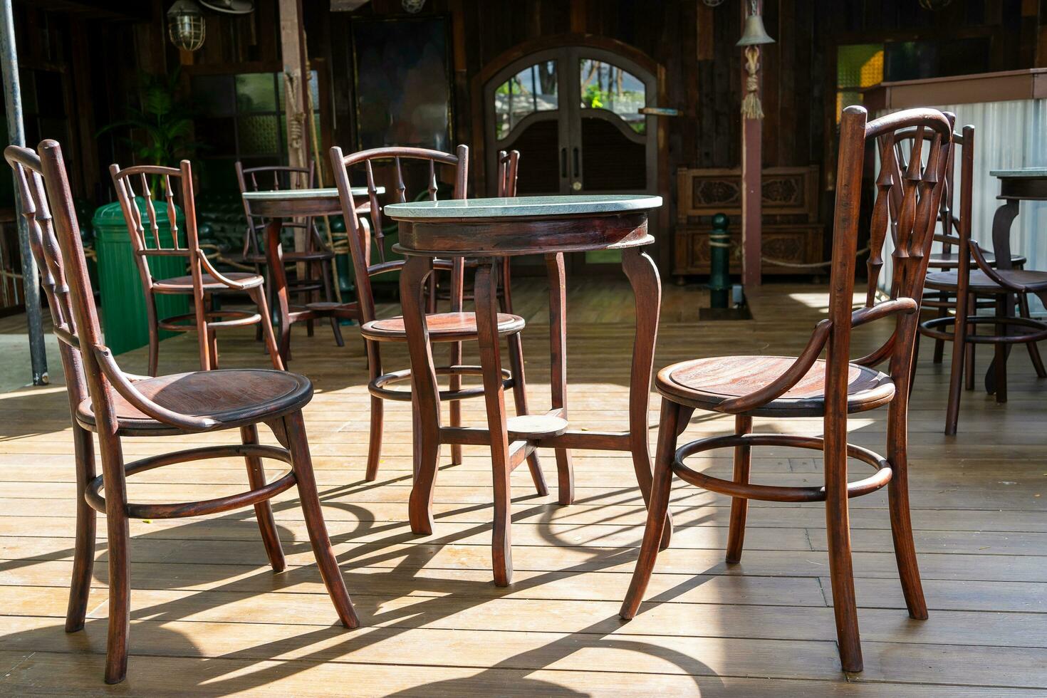 Restaurant wooden chairs against morning sunlight photo