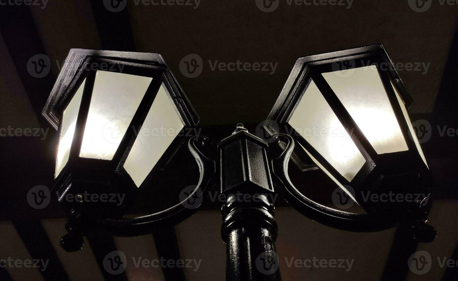 Old street lights in the dark background, vintage lamps photo