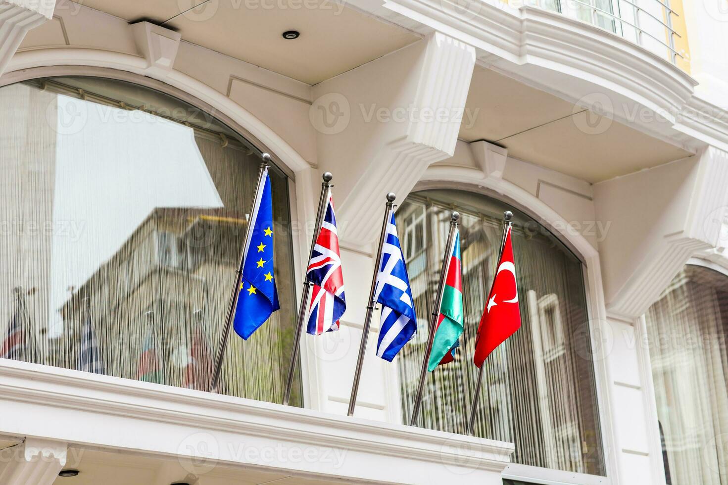 Waving flags in front of building. photo