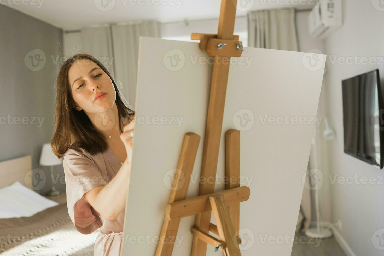 Pretty talented woman painter painting on easel making colorful sketches creating wonderful art. Beautiful female artist painting with pastel. Creativity and imagination concept photo