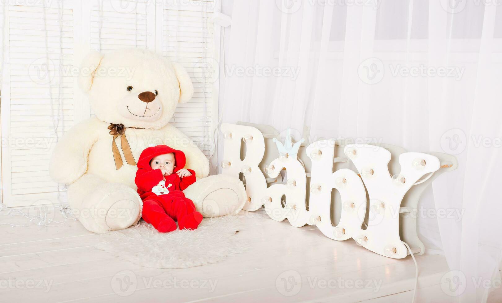 Portrait of baby with teddy bear photo