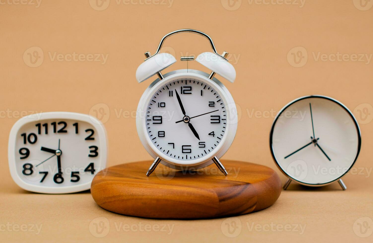 Alarm clock placed on a wooden stand, time work concept the value of limited time Appointments and punctuality at work photo