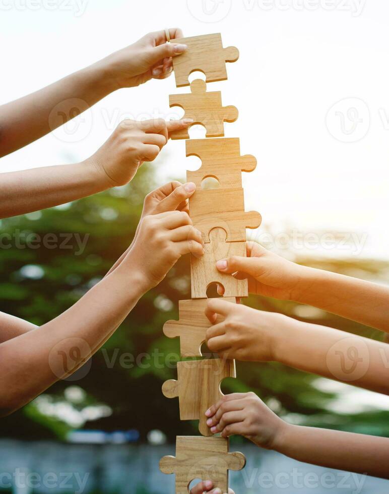 Jigsaw puzzle in hand, teamwork together communication puzzle piece teamwork concept photo